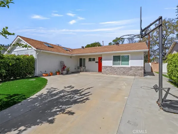 a front view of house with yard and outdoor seating