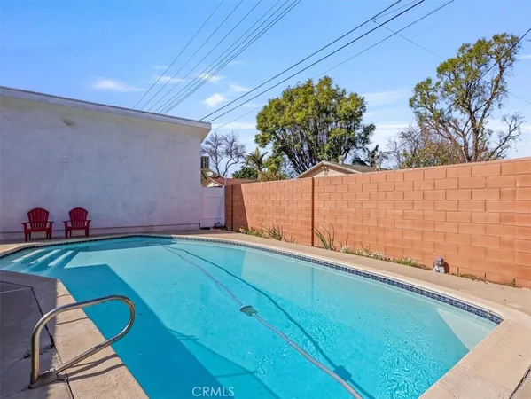 a view of a backyard with plants and a patio