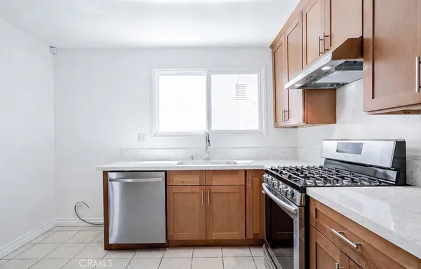 a kitchen with cabinets appliances and a window