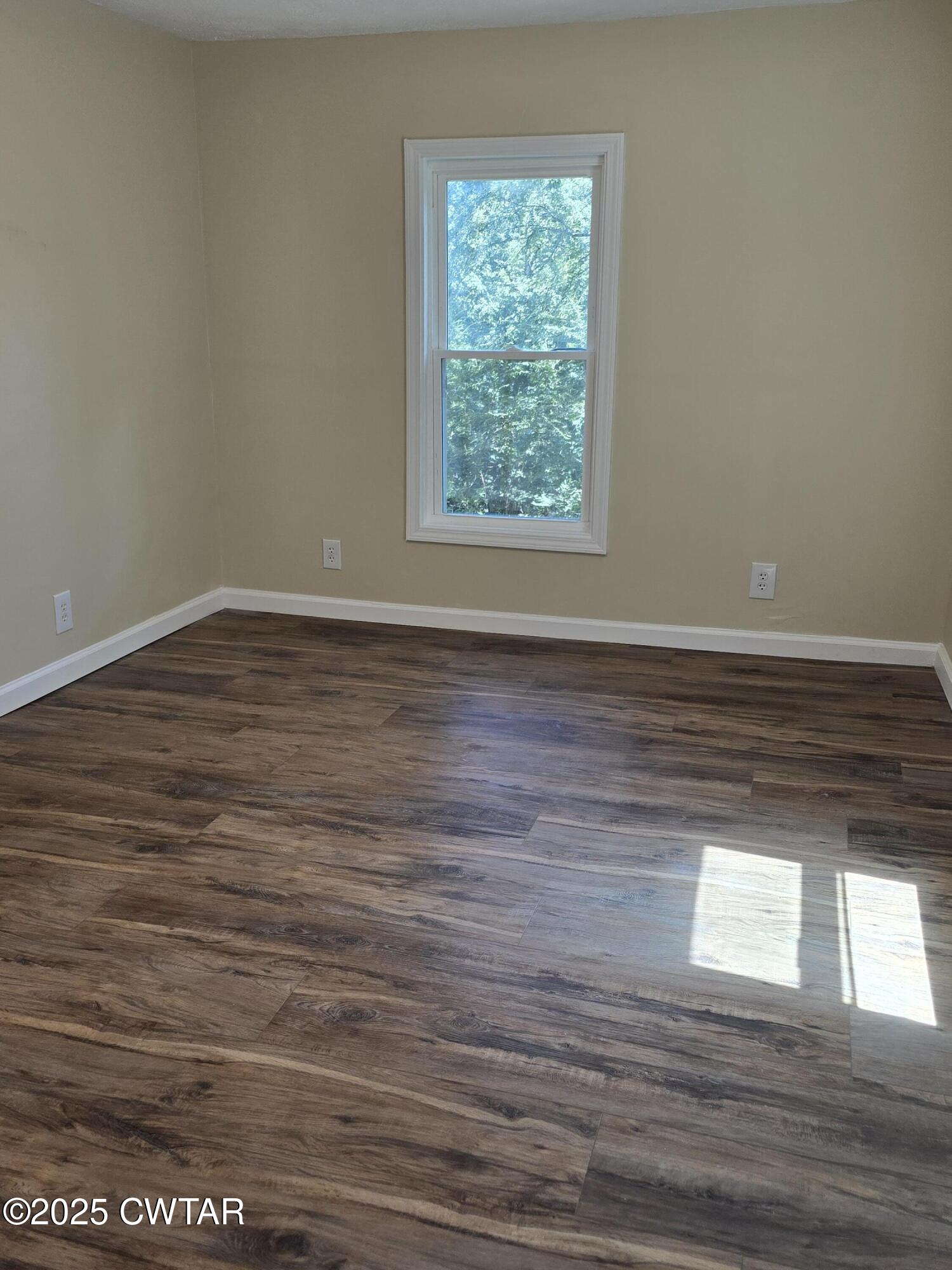 45 Lesters Chapel Road Jackson, TN 38301 - Photo 8 of 16 a view of an empty room with wooden floor and a window