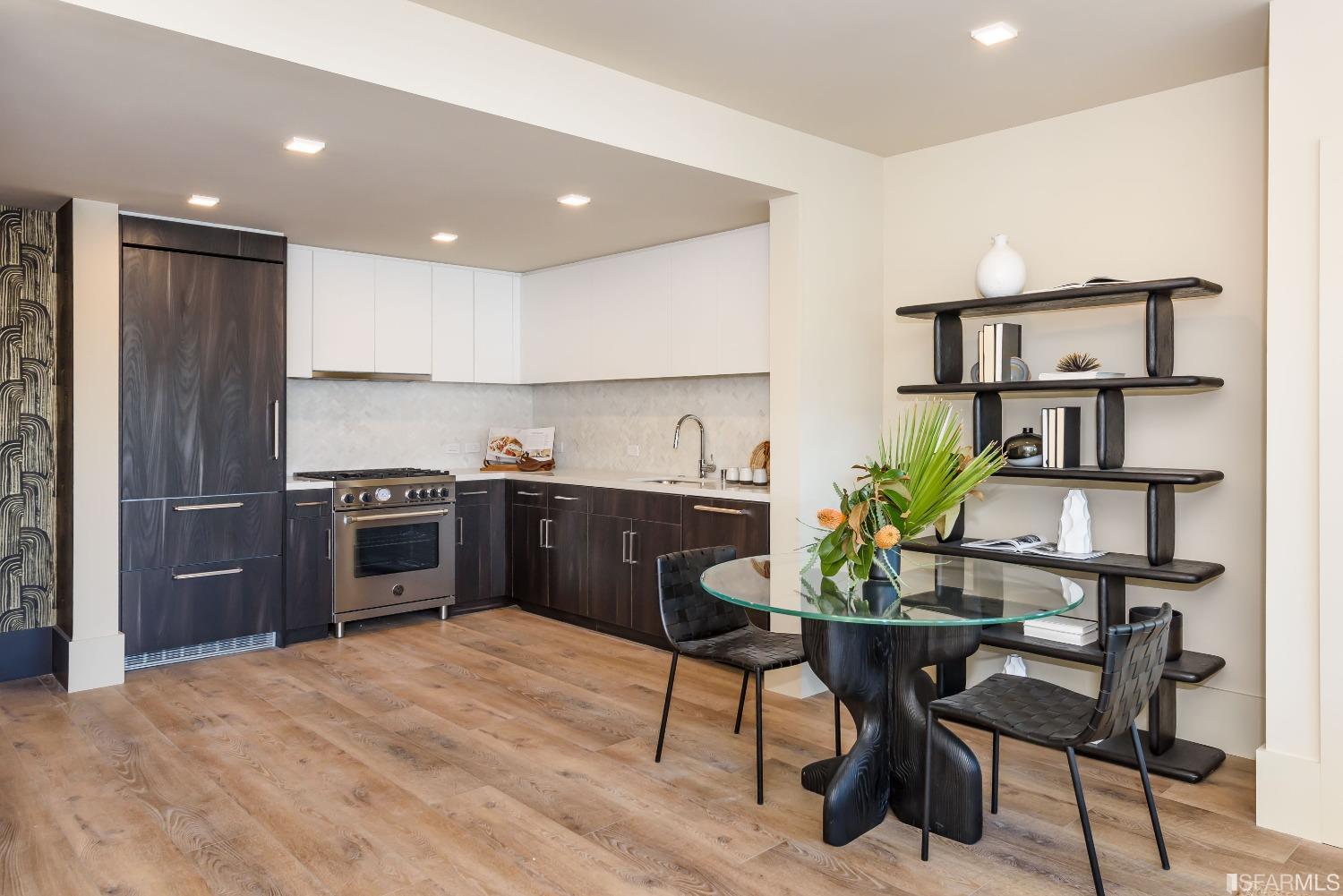 1288 Howard Street, Unit 403 San Francisco, CA 94103 - Photo 3 of 33 a kitchen with a table chairs refrigerator and microwave