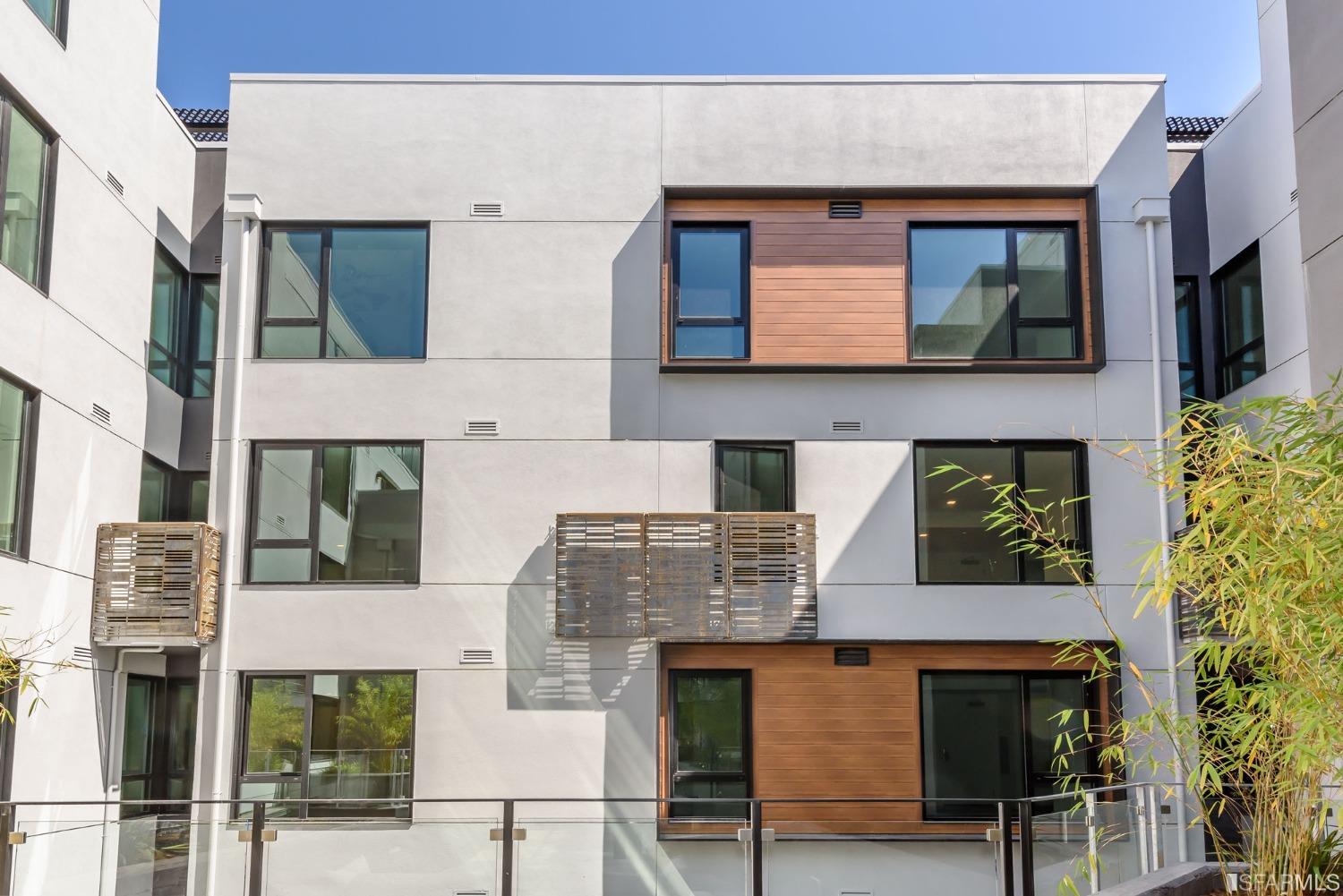 1288 Howard Street, Unit 403 San Francisco, CA 94103 - Photo 9 of 33 a front view of a building with glass windows and brick wall