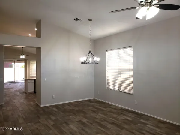 a view of a room with window ceiling fan and wooden floor