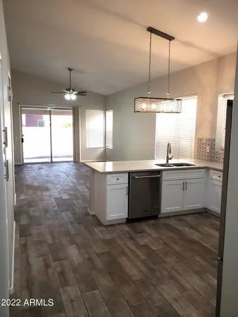 a large white kitchen with a large window