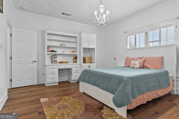 2115 Cumberland Lane Albany, GA 31707 - Photo 20 of 47 a bedroom with a large bed and a chandelier