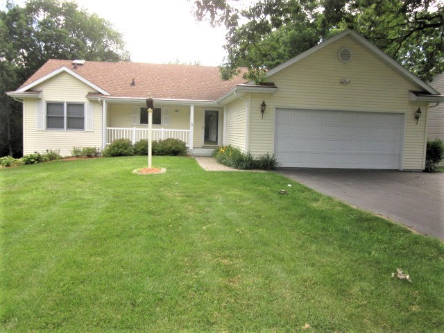 693 Lake Summerset Road Lake Summerset, IL 61019 - Photo 15 of 25 a view of a yard in front of a house with plants and large tree