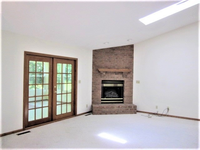 693 Lake Summerset Road Lake Summerset, IL 61019 - Photo 3 of 25 a view of an empty room with a fireplace and a window