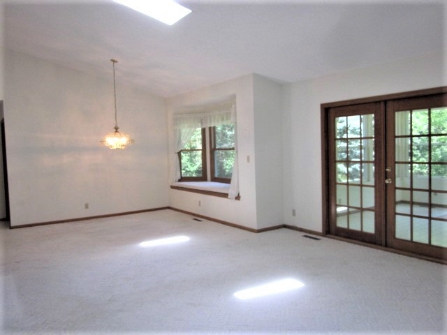 693 Lake Summerset Road Lake Summerset, IL 61019 - Photo 4 of 25 an empty room with windows and entrance