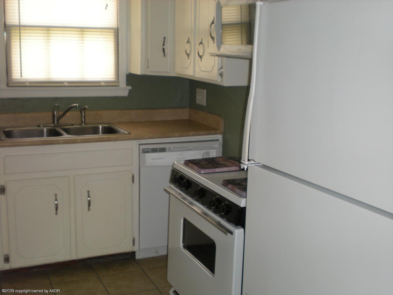 4109 Cline Road Amarillo, TX 79110 - Photo 4 of 11 a kitchen with a stove and a sink