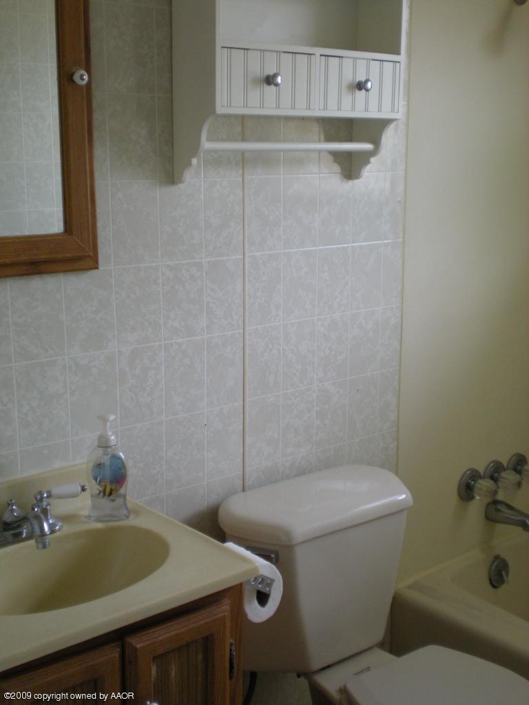 4109 Cline Road Amarillo, TX 79110 - Photo 8 of 11 a bathroom with a sink and a toilet