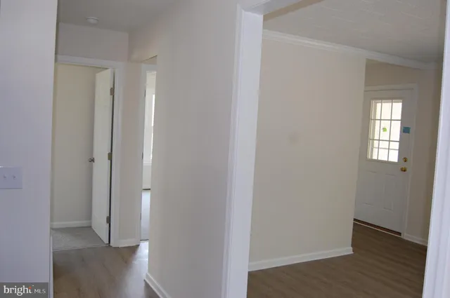 a view of hallway with wooden floor