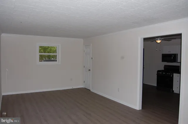 an empty room with wooden floor and closet