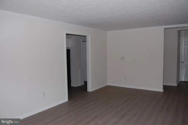 a view of a room with wooden floor