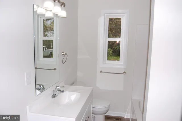 a bathroom with a sink toilet and vanity