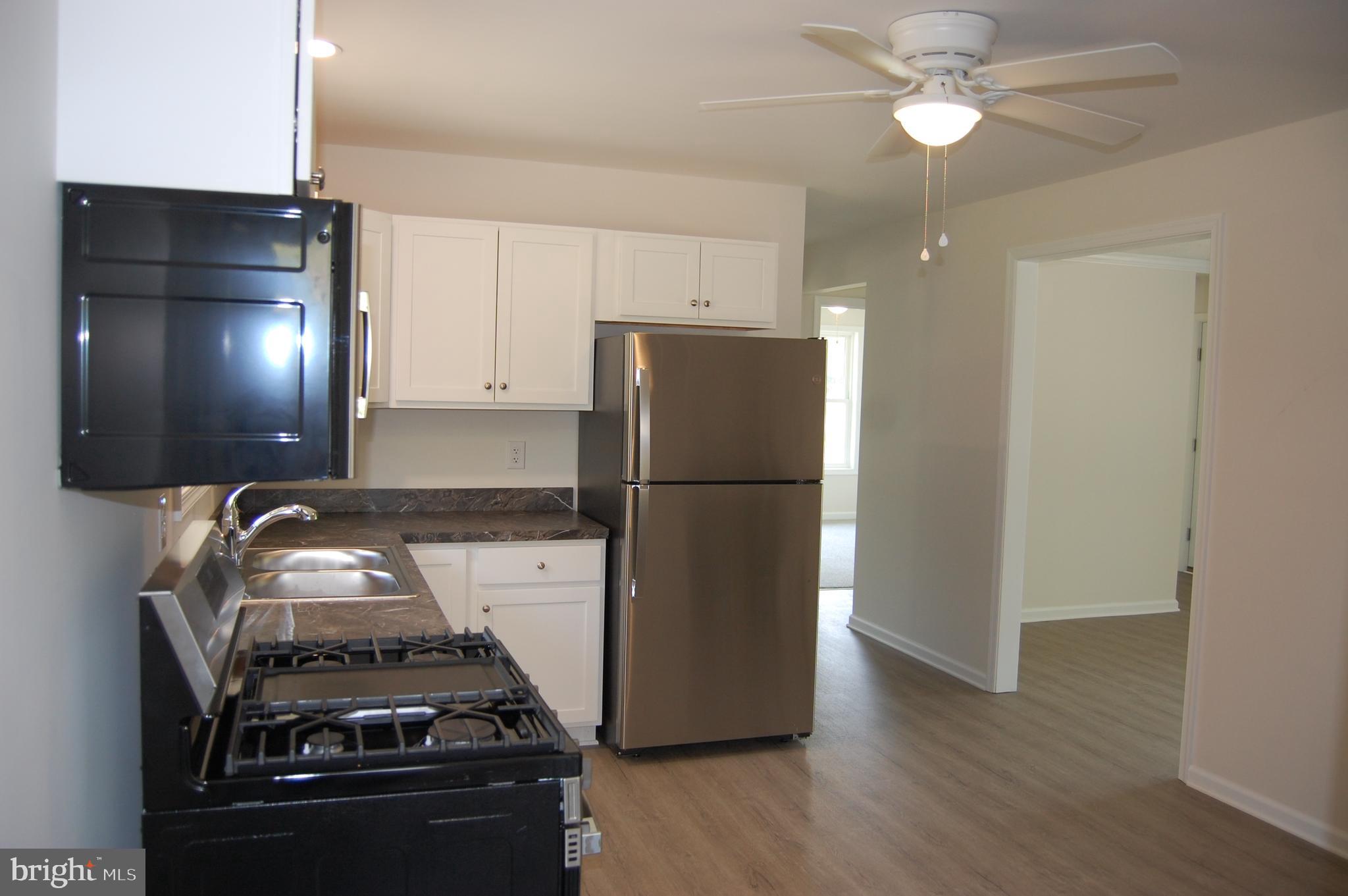 11511 Old School Road Mardela Springs, MD 21837 - Photo 28 of 34 a kitchen with a refrigerator and a stove top oven