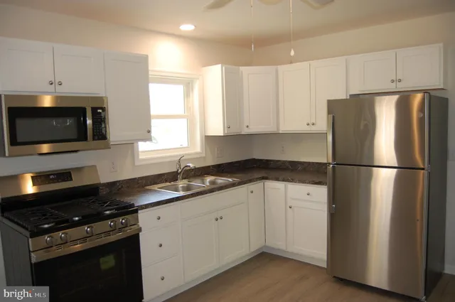 a kitchen with a refrigerator stove and microwave