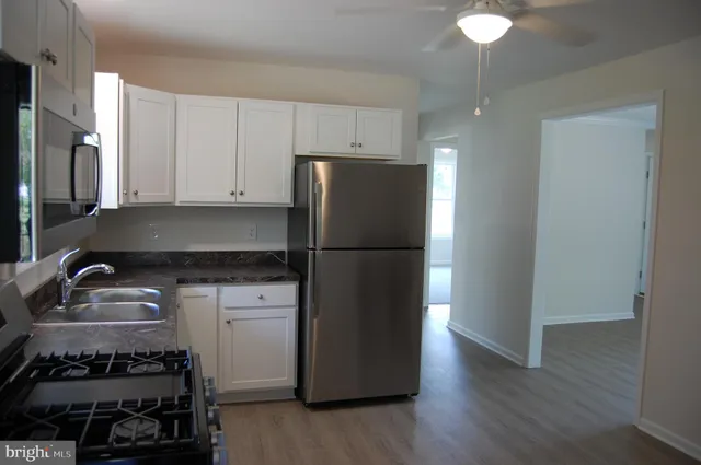 a kitchen with a refrigerator and a sink