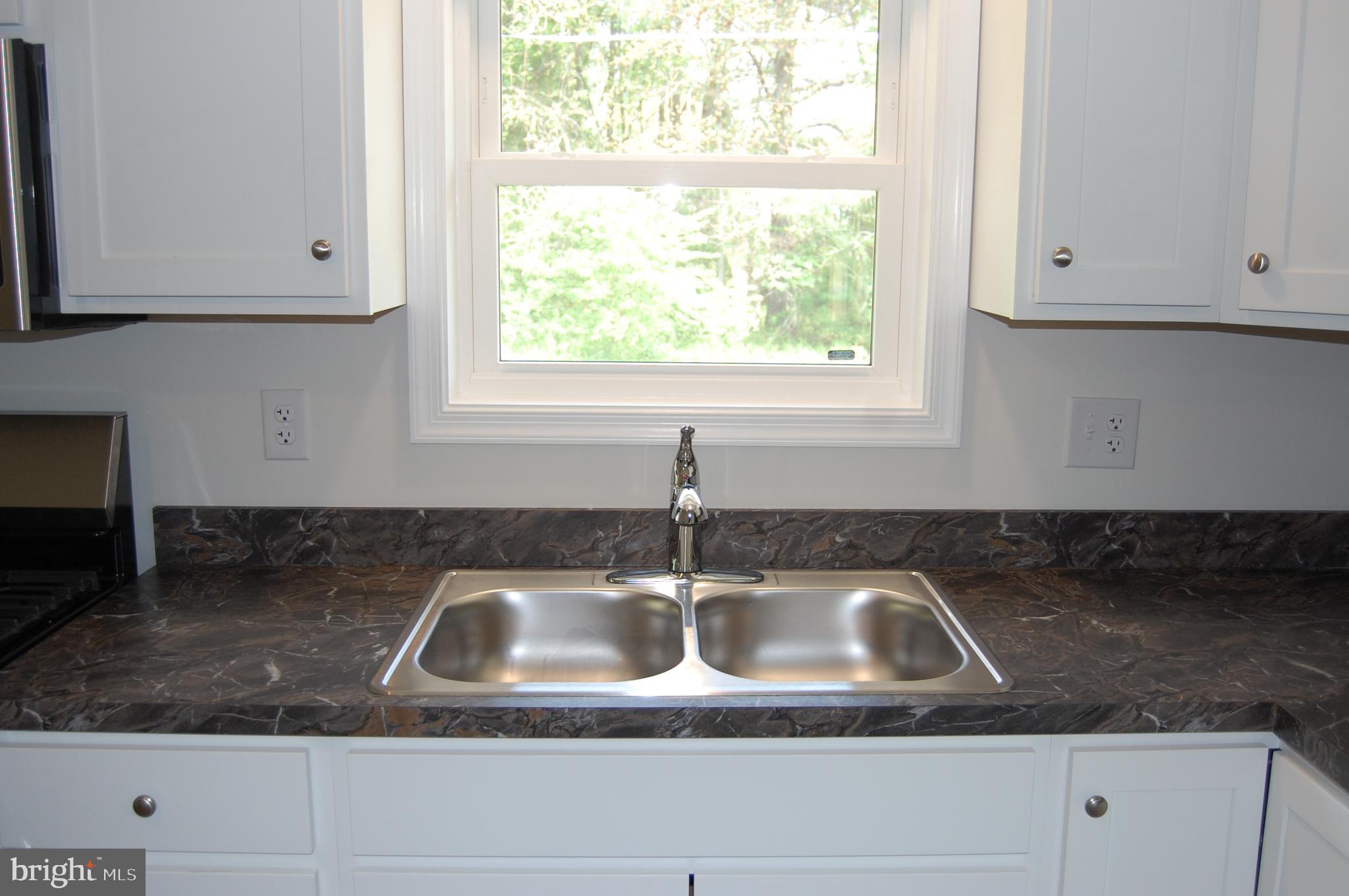 11511 Old School Road Mardela Springs, MD 21837 - Photo 8 of 34 a kitchen with granite countertop white cabinets and a sink