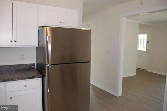 a white refrigerator freezer sitting in a kitchen
