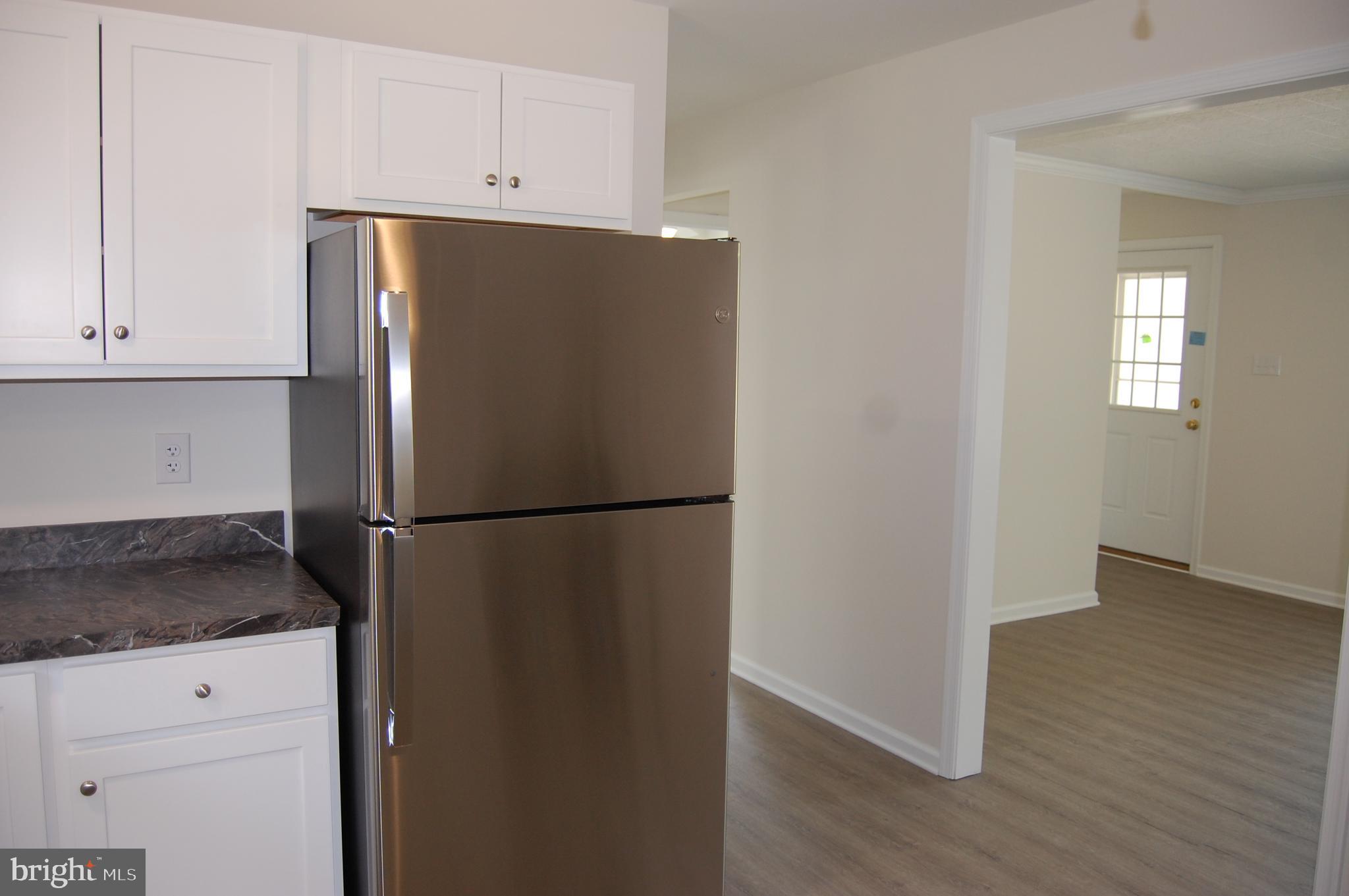 11511 Old School Road Mardela Springs, MD 21837 - Photo 10 of 34 a white refrigerator freezer sitting in a kitchen