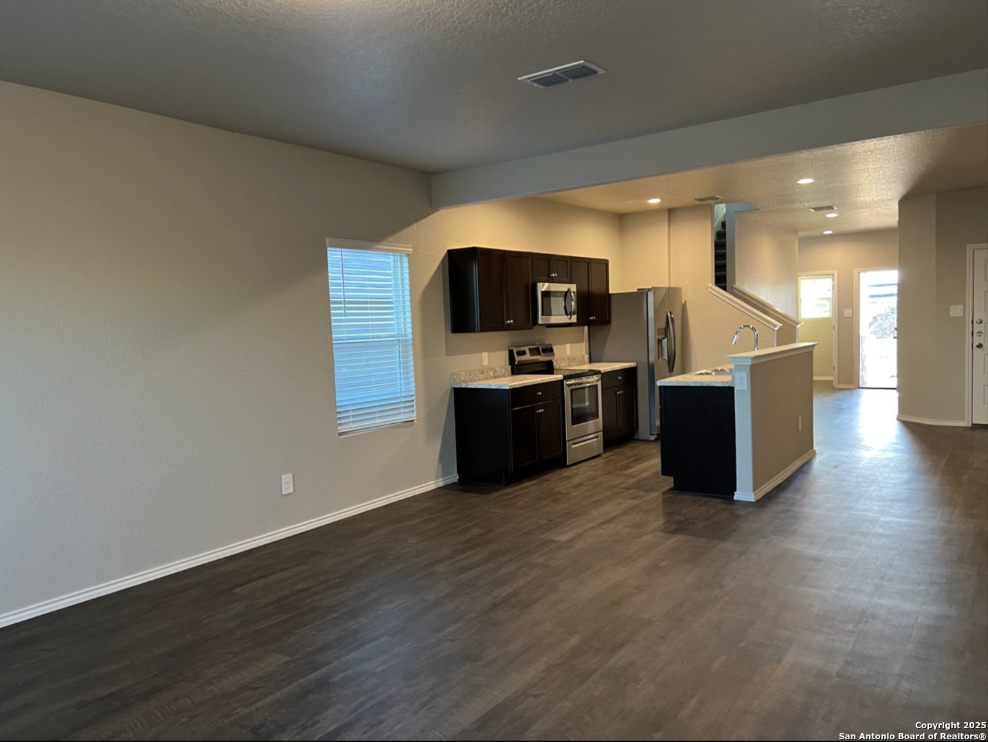 4215 Asher Alley St. Hedwig, TX 78152 - Photo 2 of 21 a kitchen with stainless steel appliances a stove top oven a sink and a refrigerator