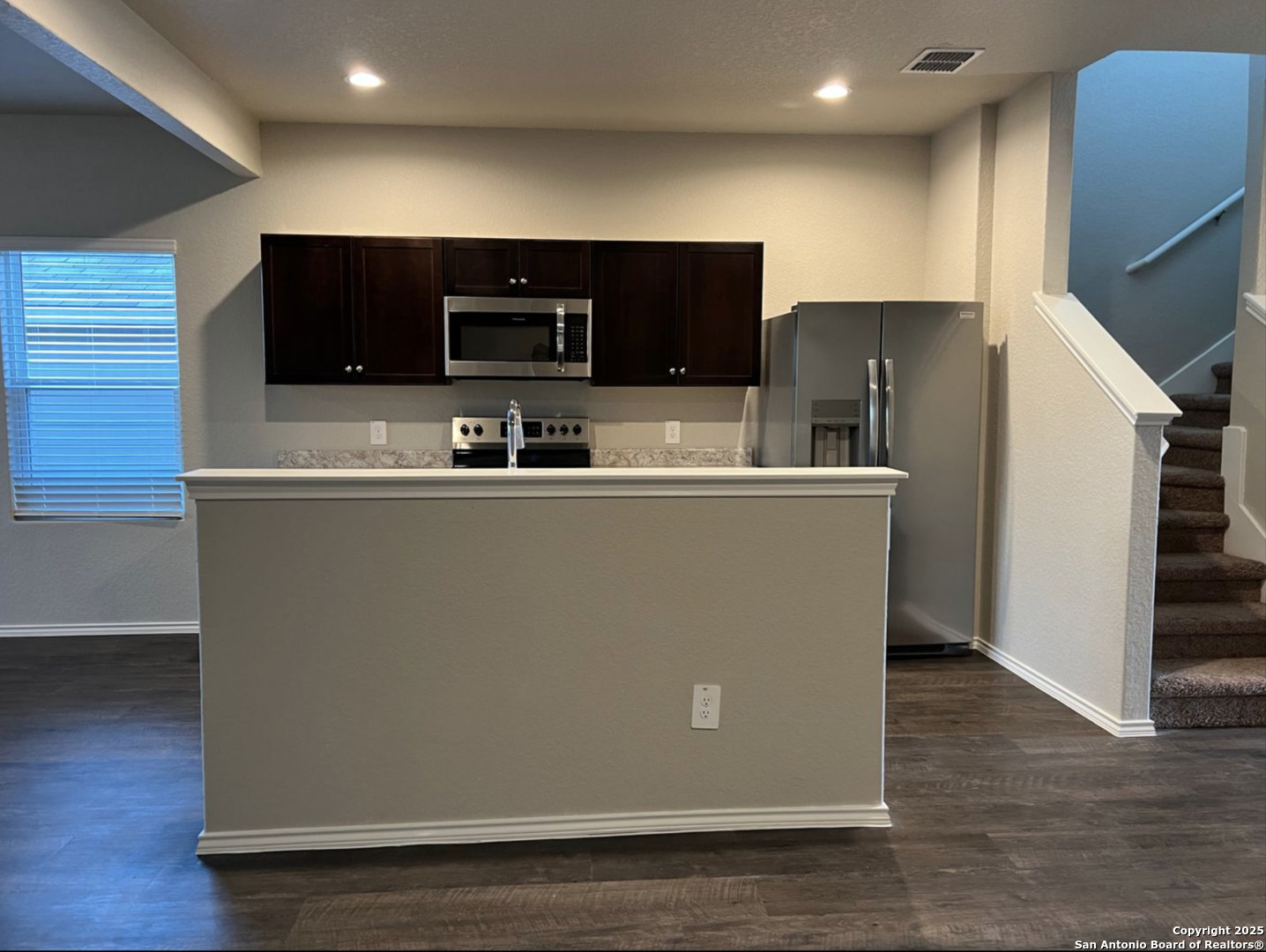 4215 Asher Alley St. Hedwig, TX 78152 - Photo 3 of 21 a view of a kitchen with stainless steel appliances wooden floor and chair