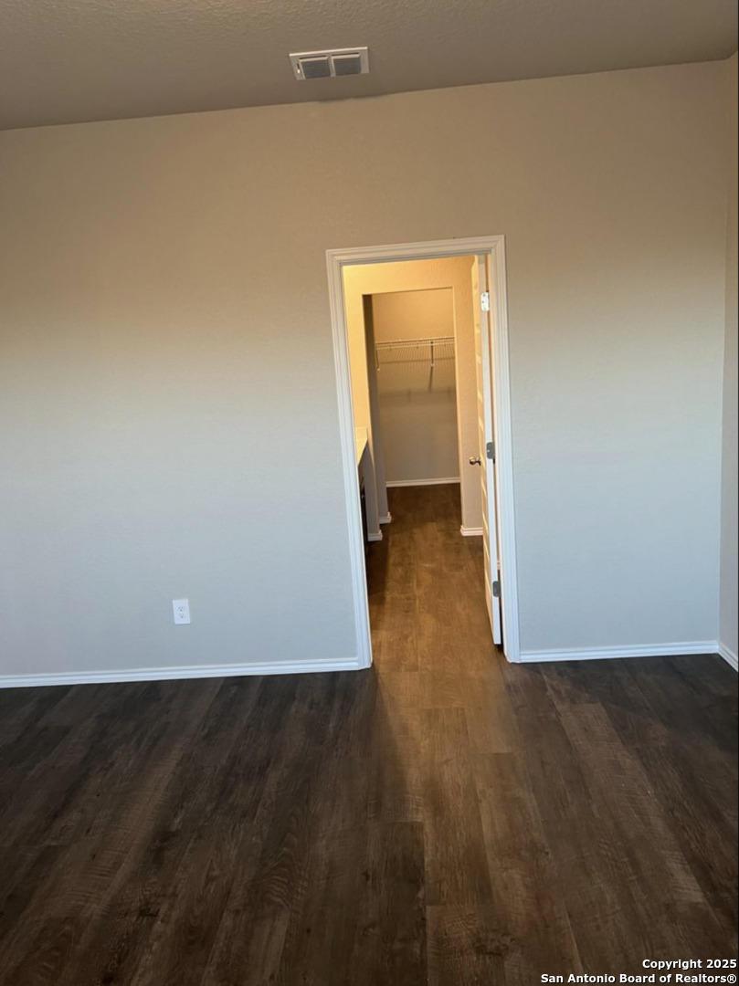 4215 Asher Alley St. Hedwig, TX 78152 - Photo 8 of 21 an empty room with wooden floor and cabinet
