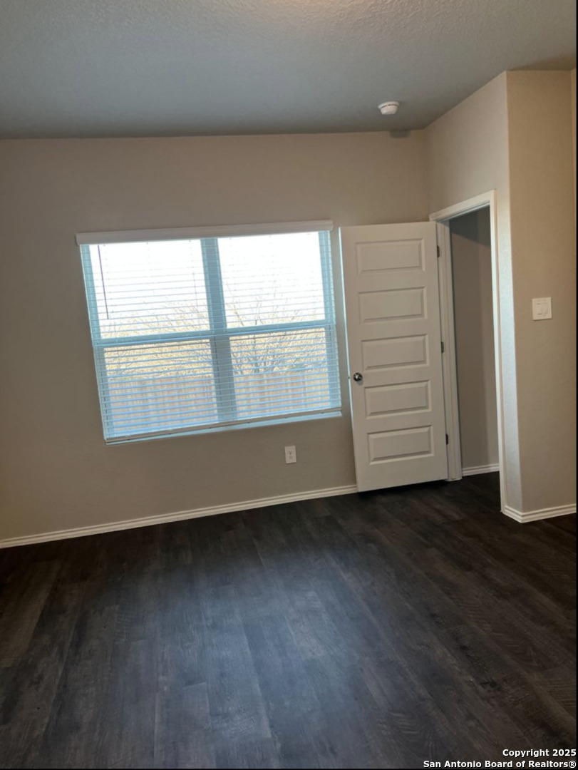 4215 Asher Alley St. Hedwig, TX 78152 - Photo 9 of 21 an empty room with wooden floor and windows