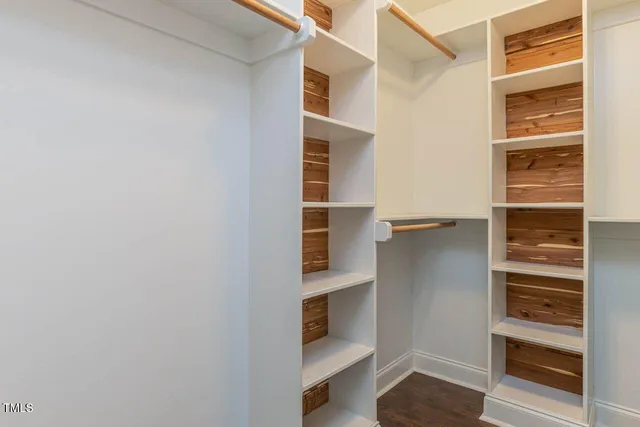 a view of walk in closet with empty racks
