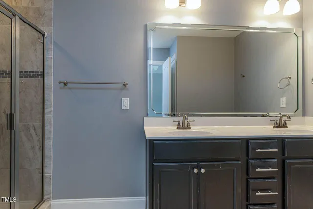 a bathroom with a double vanity sink and mirror