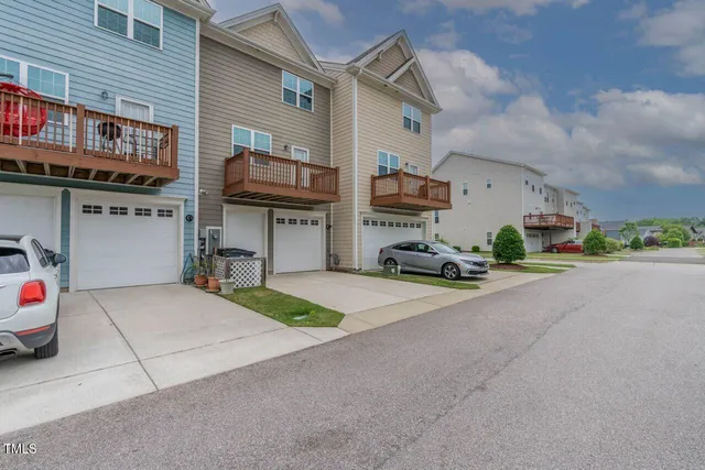 a car parked in front of a white building
