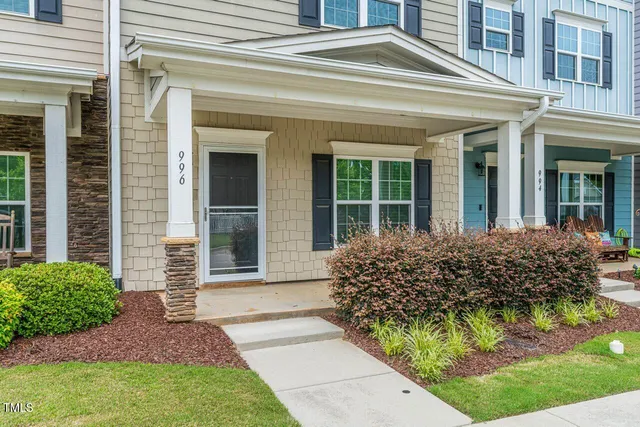 front view of a brick house with a small yard