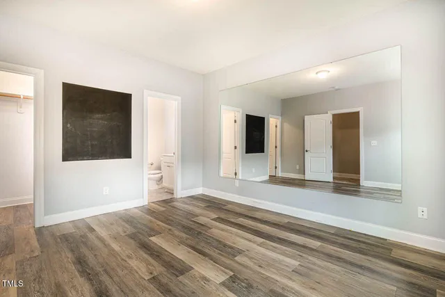 a view of a room with wooden floor and cabinet