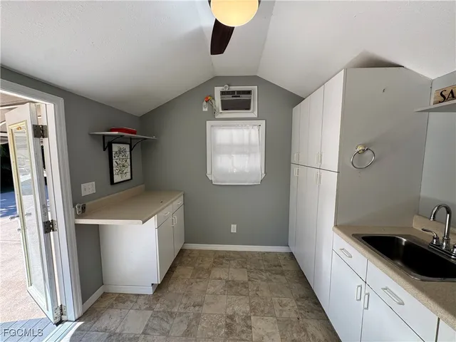 a bathroom with a granite countertop sink and a shower