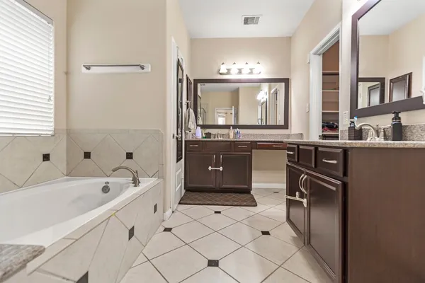 a bathroom with a sink vanity and a mirror