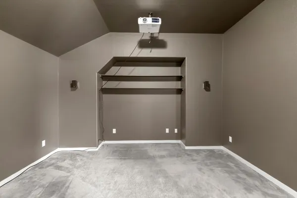 a room with furniture and a projector screen