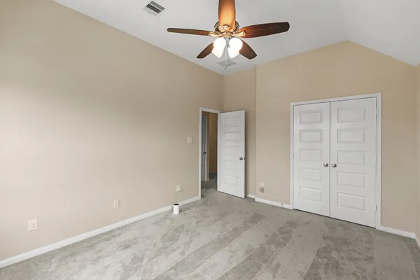 an empty room with windows and closet