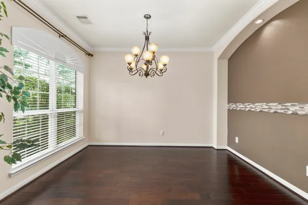 a view of a room with wooden floor and large window