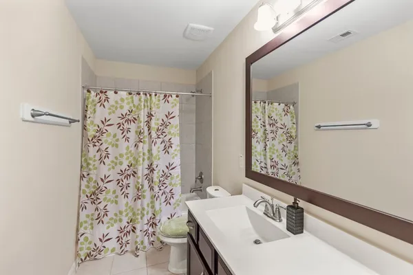 a bathroom with a sink vanity and a mirror