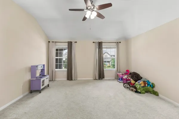 a view of a livingroom with a ceiling fan and window