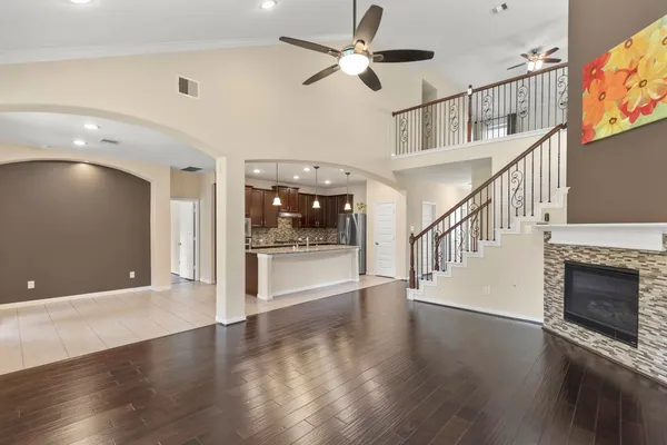 a large kitchen with kitchen island granite countertop a sink and a wooden cabinets