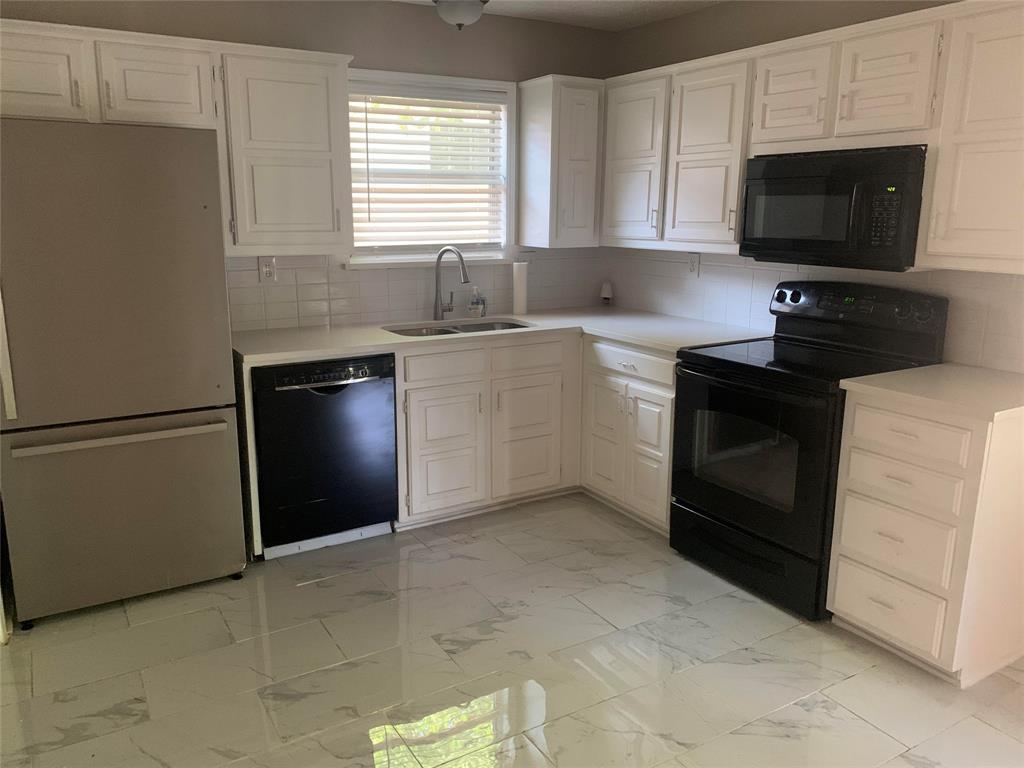 411 South Benge Street McKinney, TX 75069 - Photo 2 of 13 a kitchen with a refrigerator stove and microwave