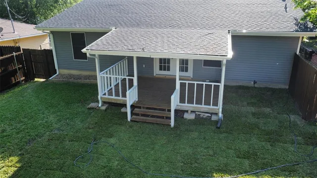 a view of a house with a yard and sitting area