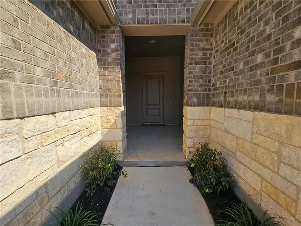 a view of an empty room and a window
