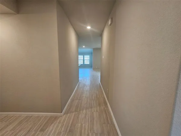 a view of a room with wooden floor and window