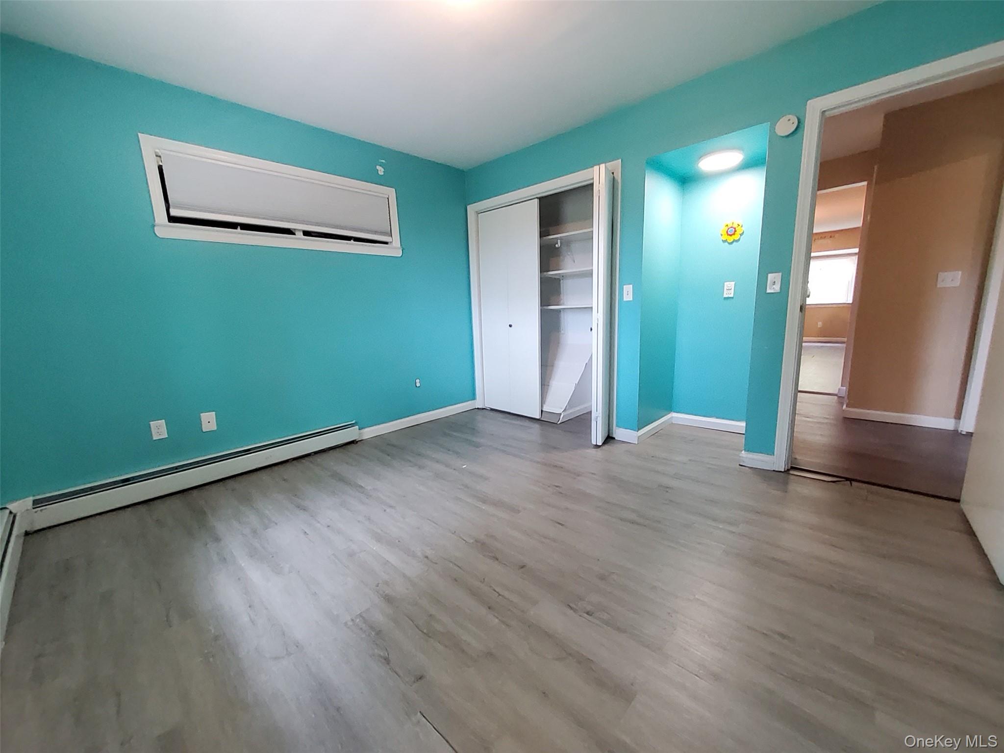 469 Hillside Road Monroe, NY 10950 - Photo 6 of 20 an empty room with wooden floor and windows