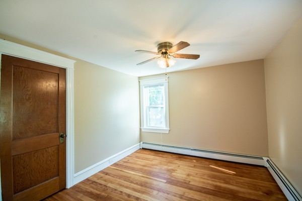 44 Bridge Street Warren, RI 02885 - Photo 13 of 30 wooden floor in an empty room with a window