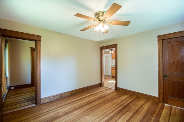 44 Bridge Street Warren, RI 02885 - Photo 17 of 30 an empty room with wooden floor and door