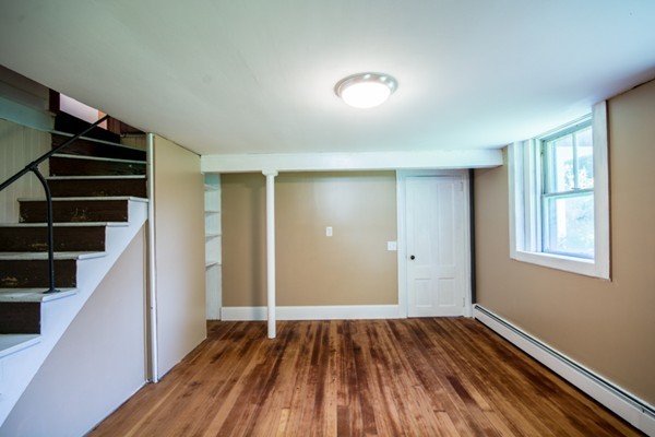 44 Bridge Street Warren, RI 02885 - Photo 29 of 30 a view of an empty room with wooden floor and stairs