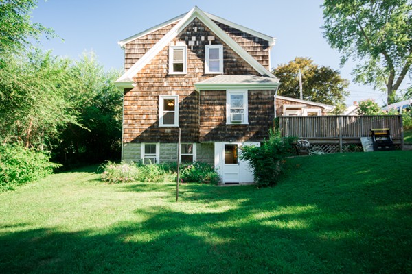 44 Bridge Street Warren, RI 02885 - Photo 4 of 30 a front view of a house with a yard and trees